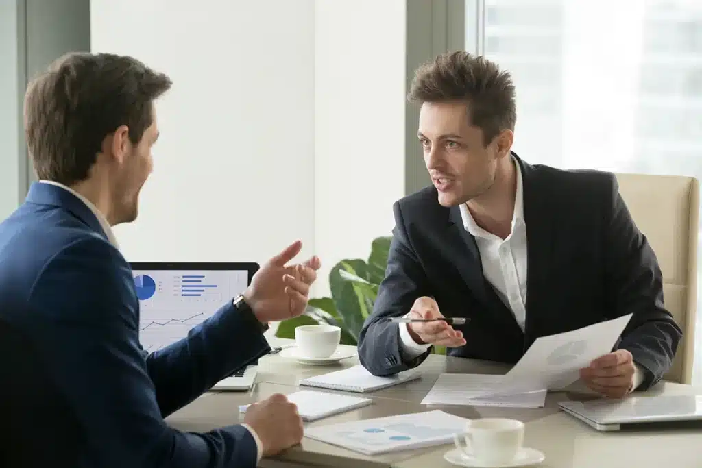Image of two professionals discussing accounting